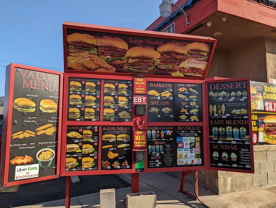 Fast food counter with seating nearby.