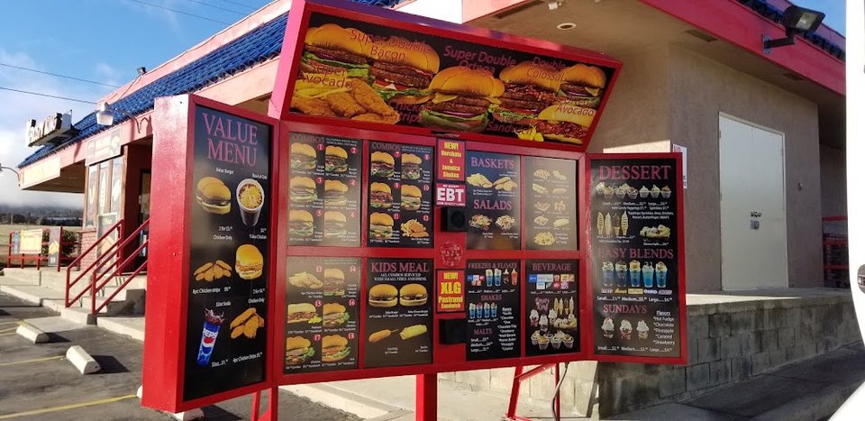 Menu board for burgers, shakes, and ice cream.